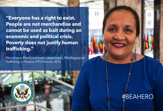 Eine Frau in einem blauen Kleid steht lächelnd vor einem Gebäude mit einem Zitat über Menschenrechte, mit Menschen, Pflanzen und Fahnen im Hintergrund und einem Logo und Text auf der linken Seite.